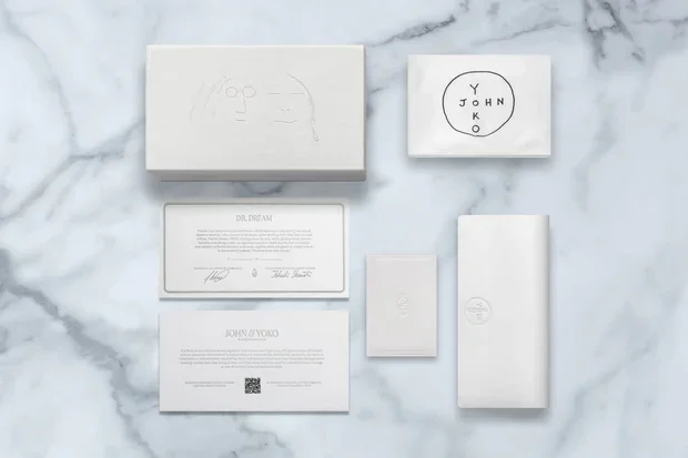 DR. DREAM John & Yoko collection packaging — bespoke monograph box, envelope-style case, cleaning cloth, and numbered authenticity card