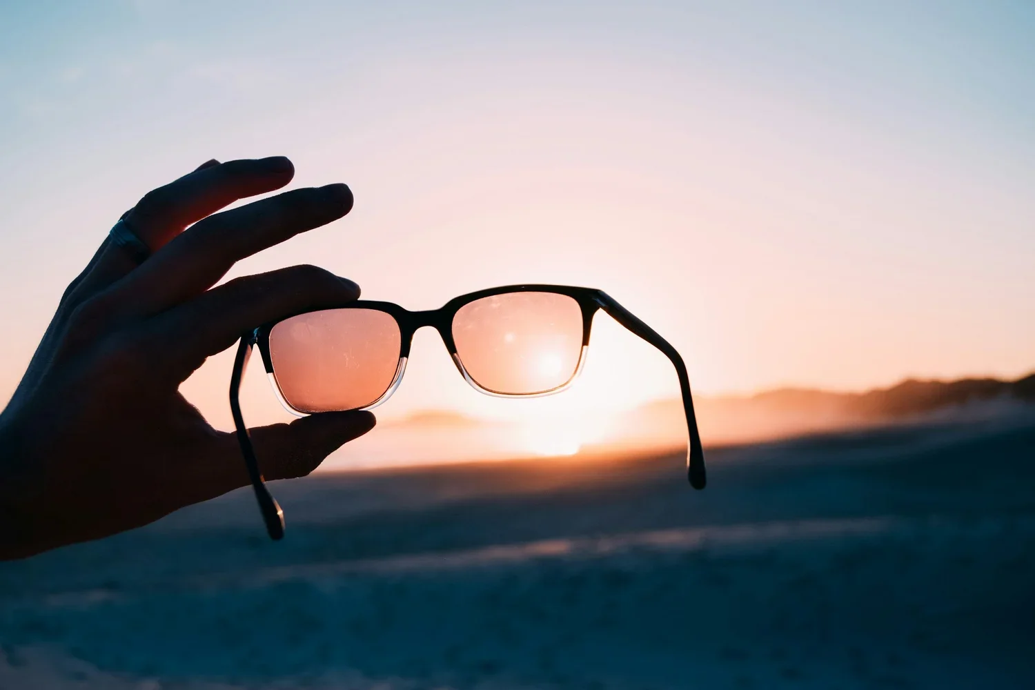 Close-up of eyeglass lenses catching light, illustrating the visual difference between lens technologies